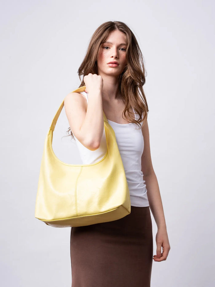 Boho-chic distressed leather tote, a free-spirited women's shoulder bag