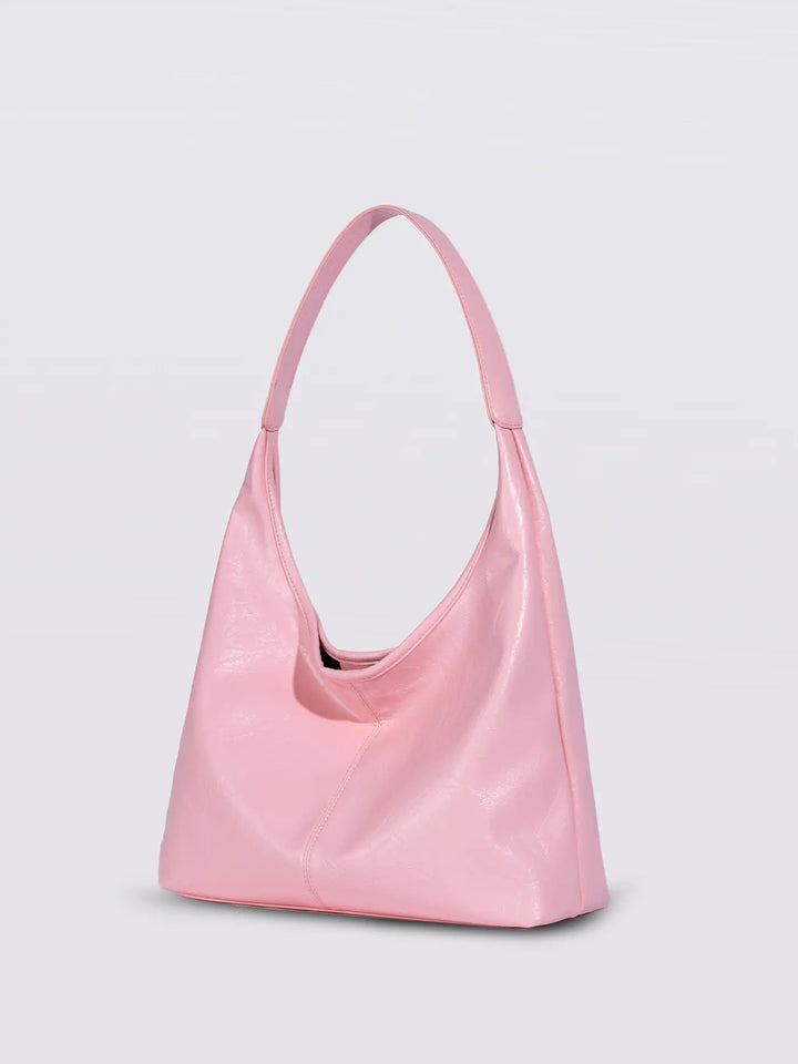 Distressed leather tote against a neutral background, highlighting texture