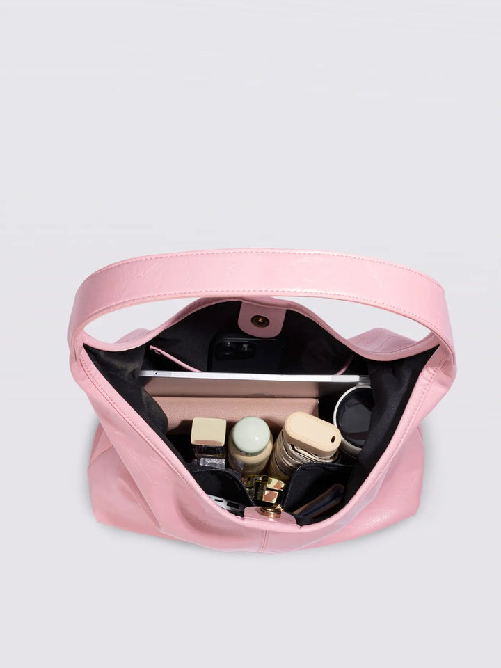 Women's distressed leather tote in an outdoor setting, showcasing versatility