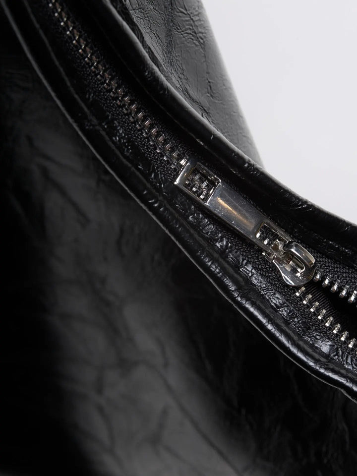 Distressed leather tote in a flat lay, presenting its full form