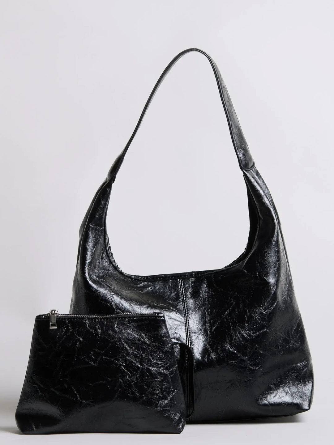 Distressed leather tote on a hanger, showcasing its structure and form