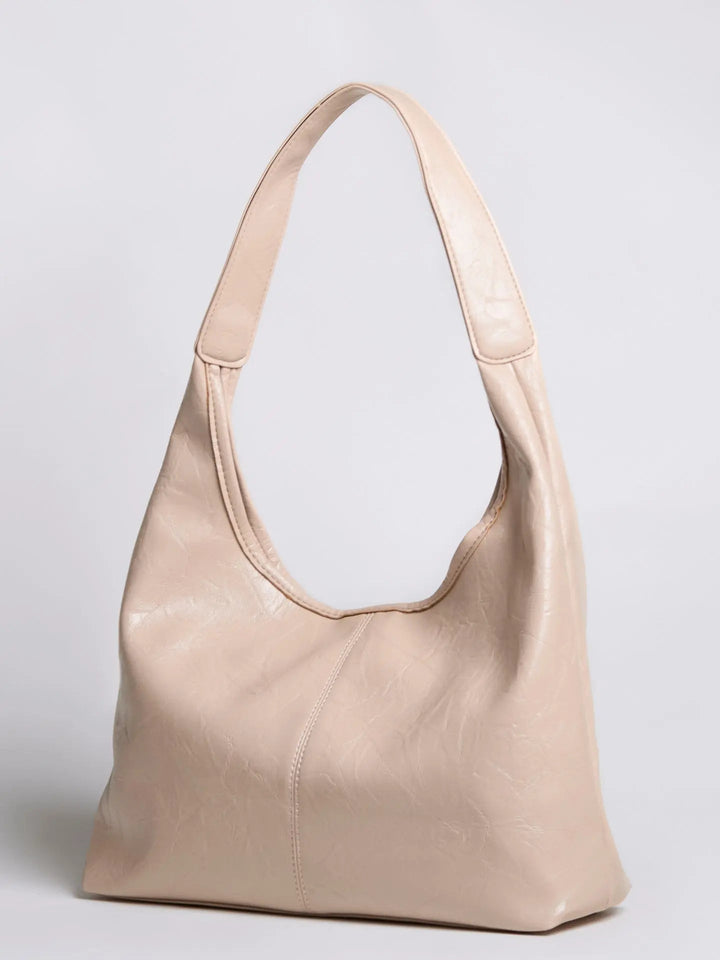 Distressed leather tote in natural light, enhancing its rich color