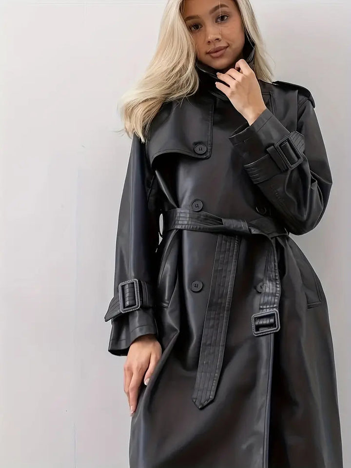 Stylish women's fall fashion coat: black double-breasted faux leather trench with belt.