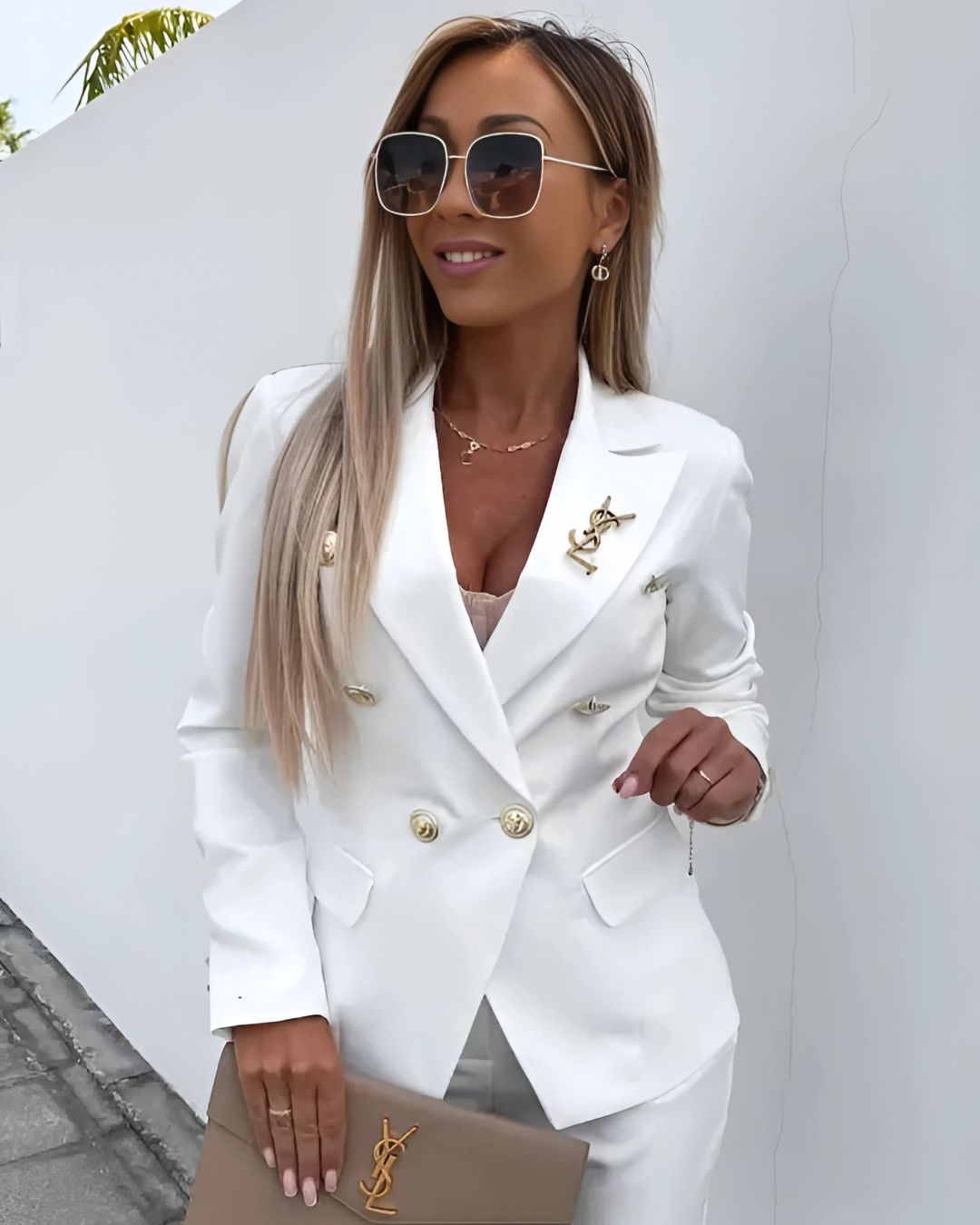 Classic women's double-breasted suit featuring a tailored jacket and slim-fit trousers, professional.