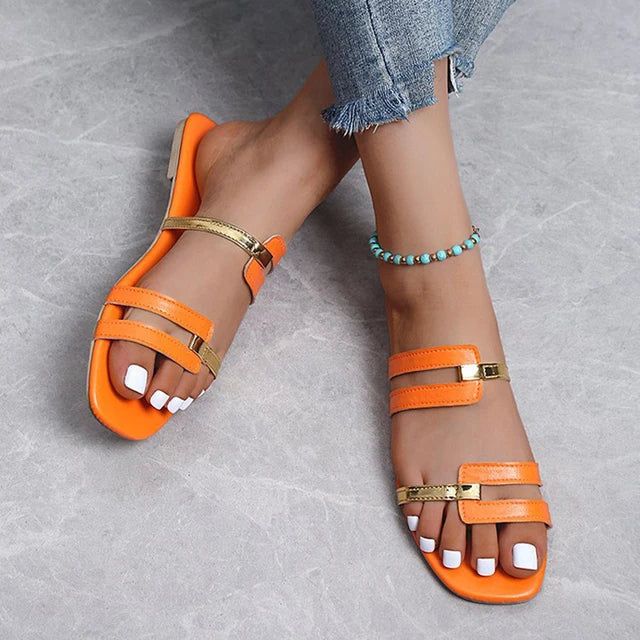 Comfortable women's flat slides with double straps & gold accents, ideal open-toe summer shoes.