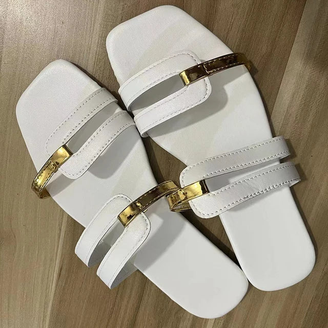 Casual women's double strap flat sandals with gold accents, great for summer or beach wear.
