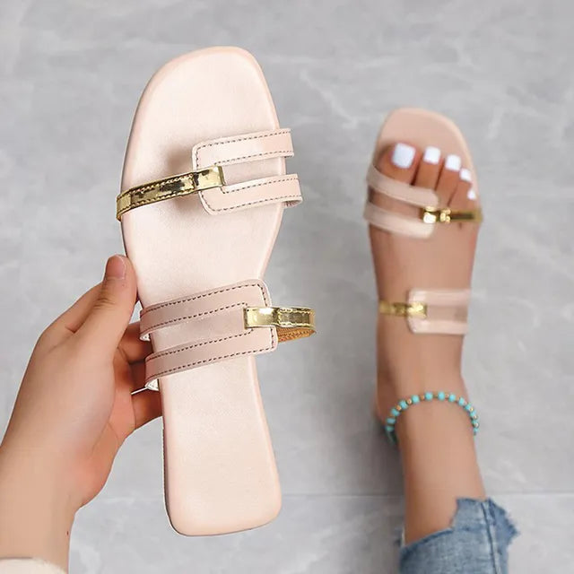 Women's flat slides, double strap with gold details. Comfortable open-toe summer sandals.
