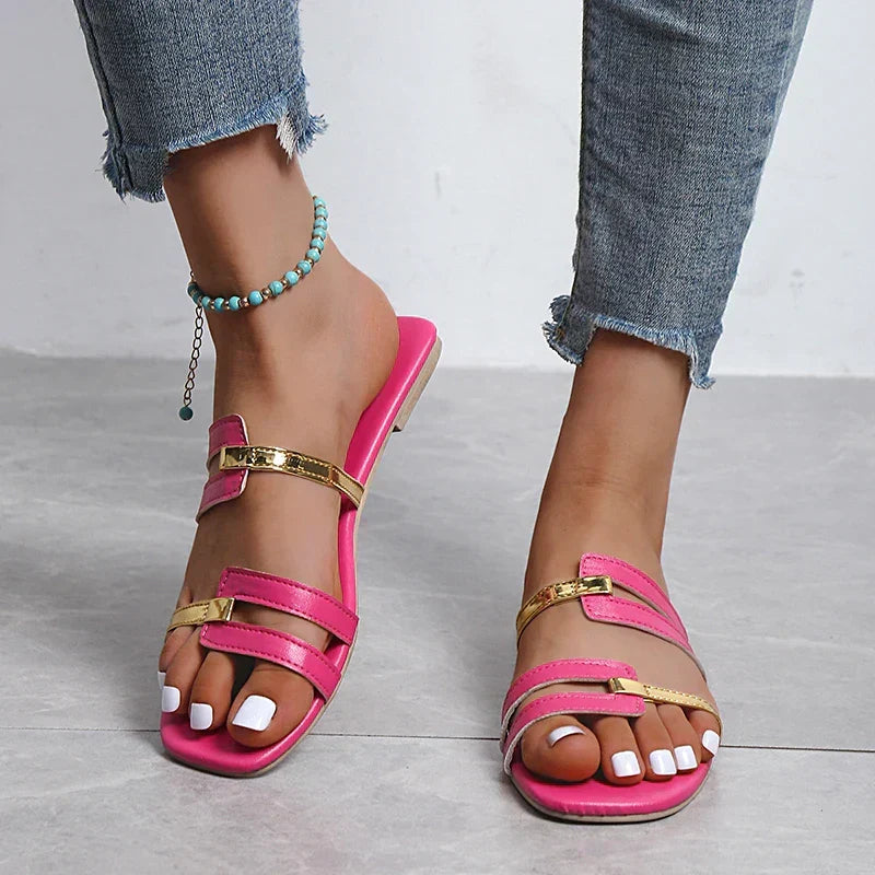 Elegant women's double strap flat sandals, slip-on style with prominent gold details. Perfect for summer.