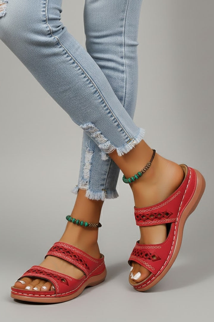 Close-up of the unique cutout design on the straps of women's slide sandals, comfort footwear.