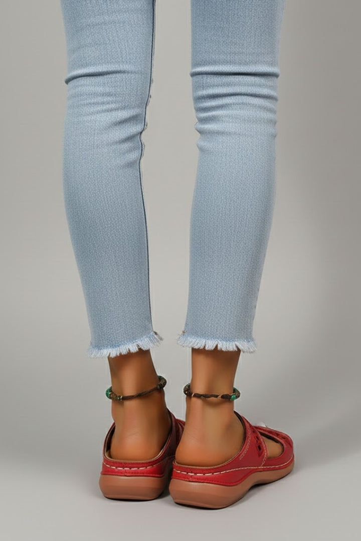 Women's dual strap slide sandals in white, showcasing easy slip-on design and decorative cutouts.