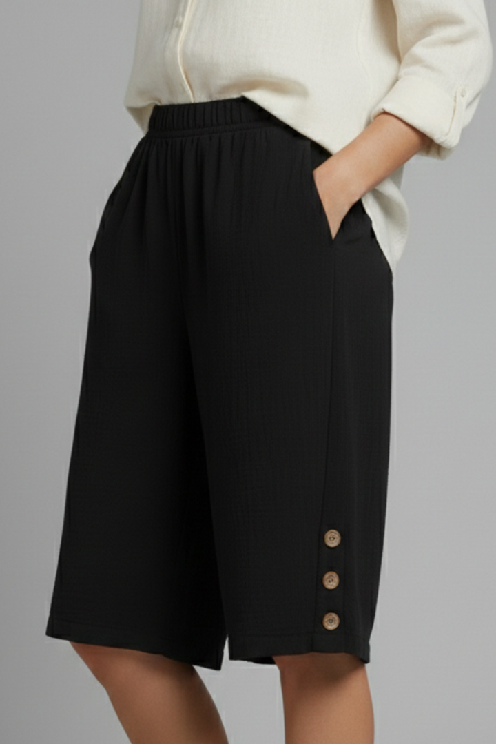 Casual women's elastic waist wide leg shorts with front button accents, ideal for warm weather.