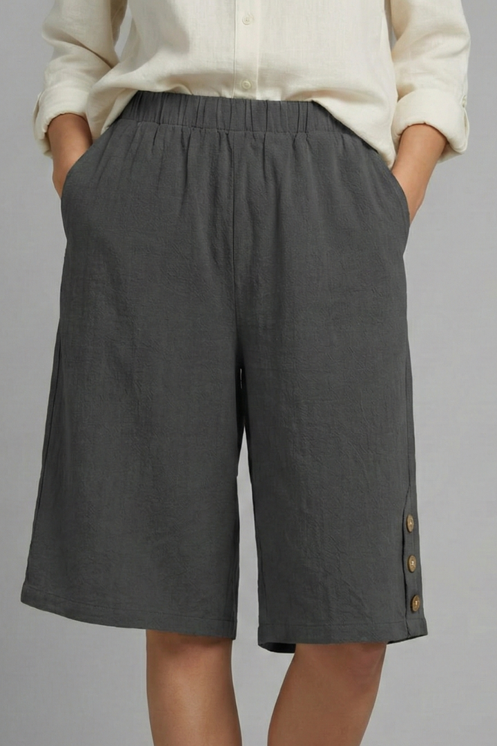 Relaxed fit wide leg shorts for women with elastic waist and unique button detailing, comfortable fashion.