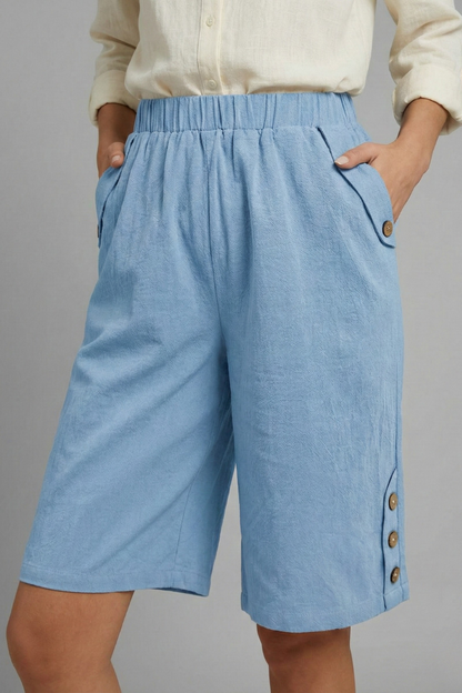 Summer-ready women's shorts: wide leg design, elastic waistband, and cute button embellishments.