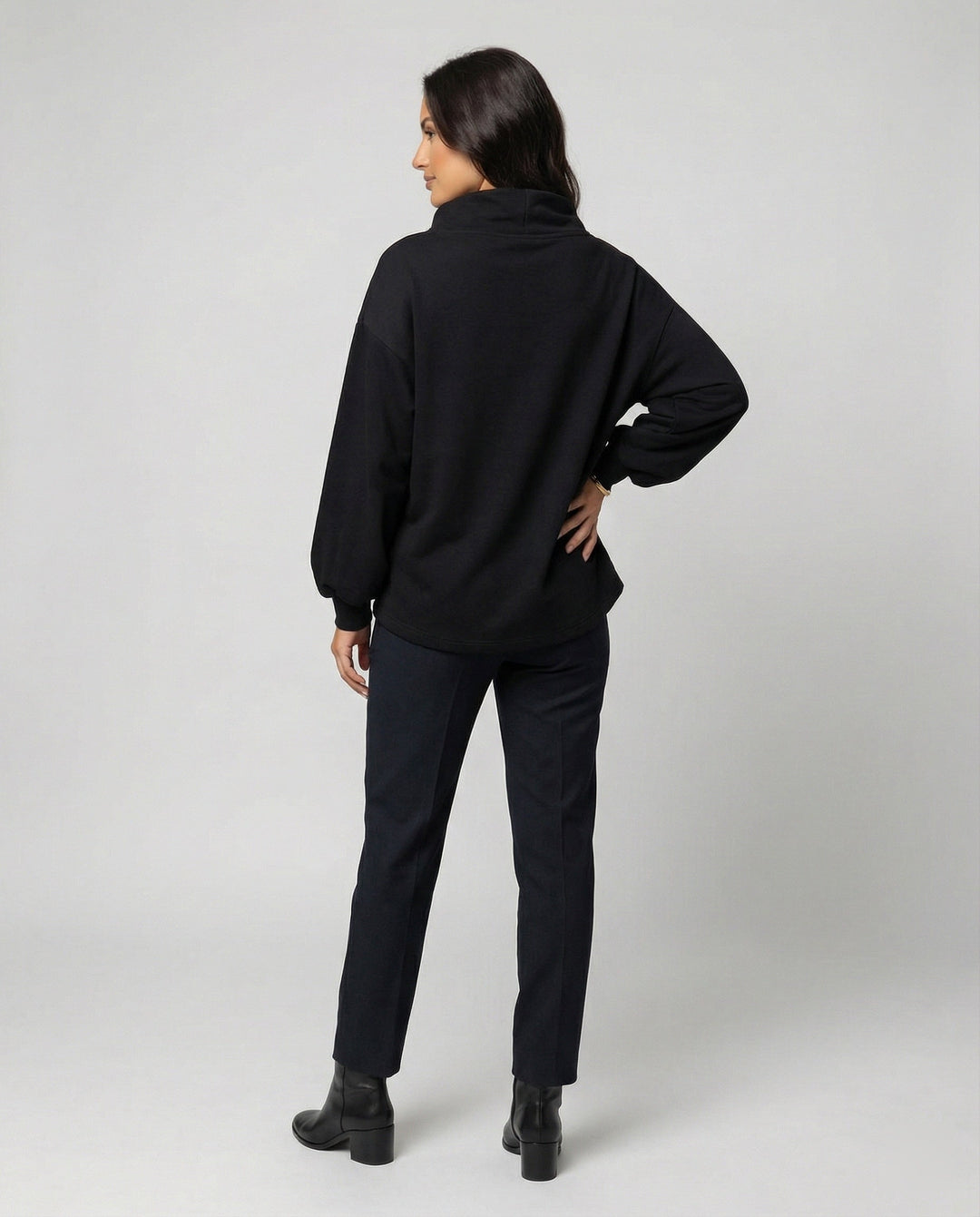 Comfortable women's long sleeve black knit sweater, offering an elegant fit for versatile fall fashion.