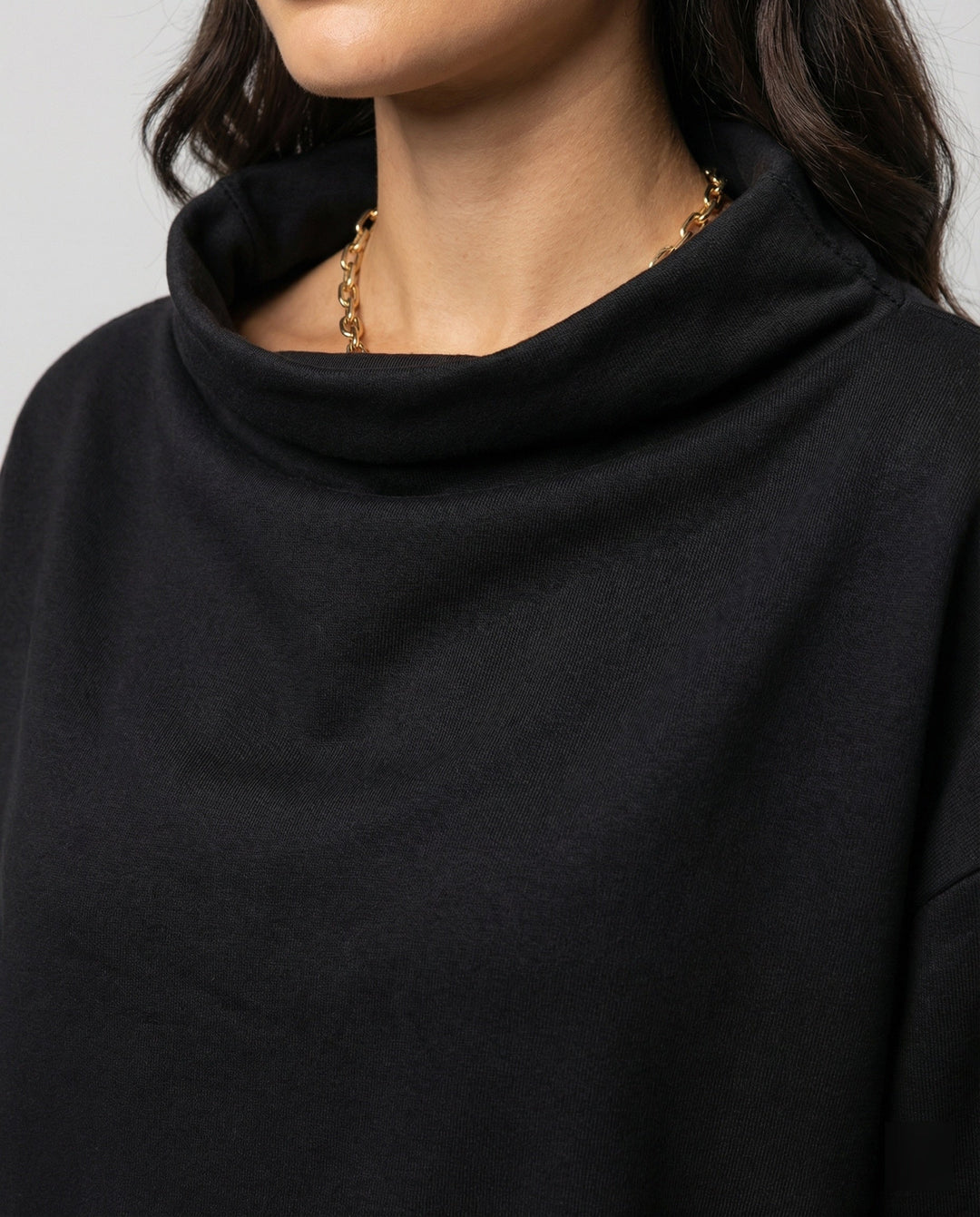 Elegant women's black knit sweater, a cozy & soft long sleeve top for comfortable winter wear.