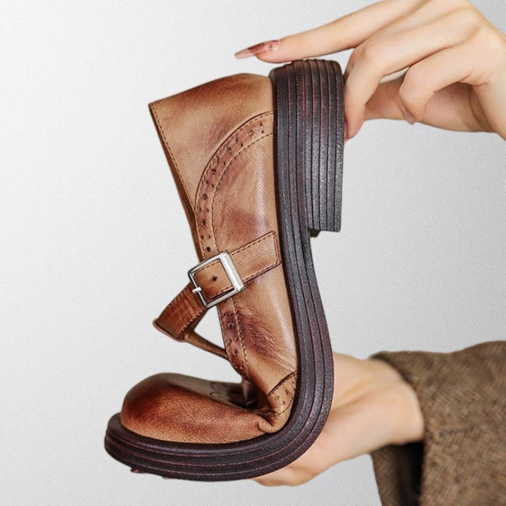 Close-up of women's elegant leather loafers, perforated design, showcasing comfort and vintage workwear style