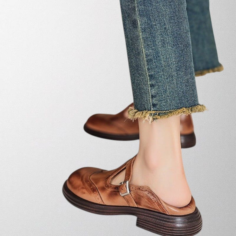 Pair of women's comfortable leather loafers in a neutral color, perforated, ideal for casual and workwear