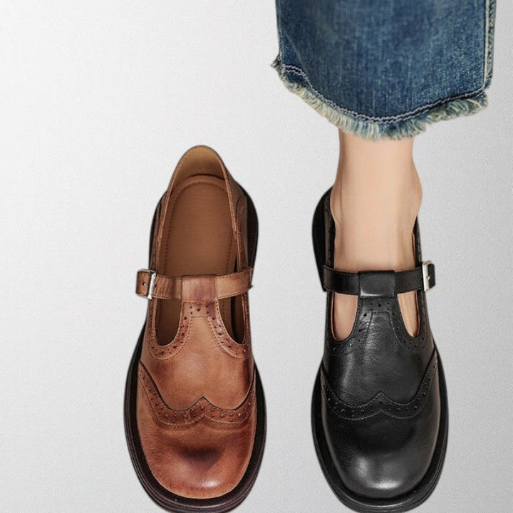 Side view of women's slip-on leather loafers, elegant and vintage style with decorative perforations