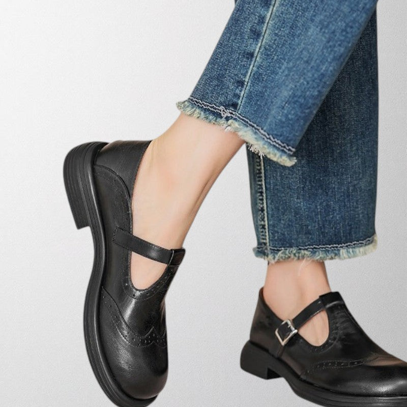 Stylish women's leather loafers with intricate perforated detailing, combining comfort and vintage elegance