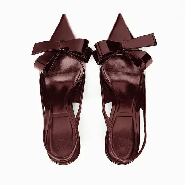 Chic women's pointed toe heels with bow detail, comfortable slingback design for parties.