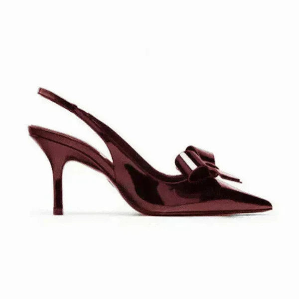 Sophisticated women's pointed toe slingback heels featuring a decorative bow, great for elegant occasions.