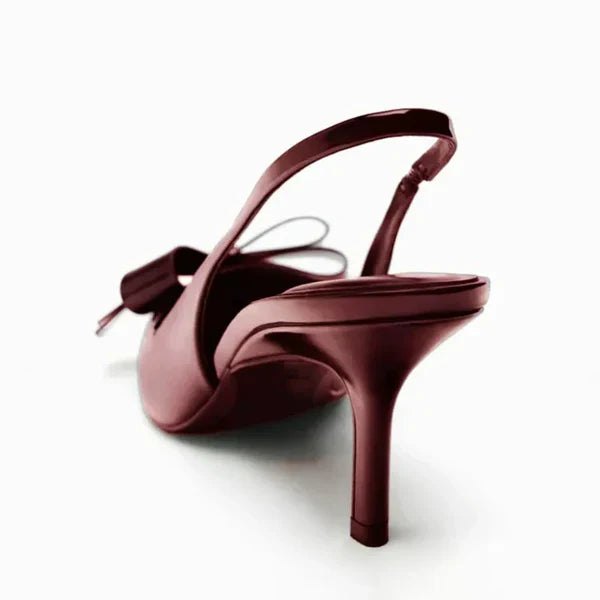 Fashionable women's stiletto heels with bow and slingback strap, pointed toe design for party attire.