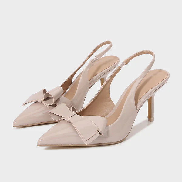 Black women's pointed toe heels with decorative bow and secure slingback strap, elegant evening shoes.