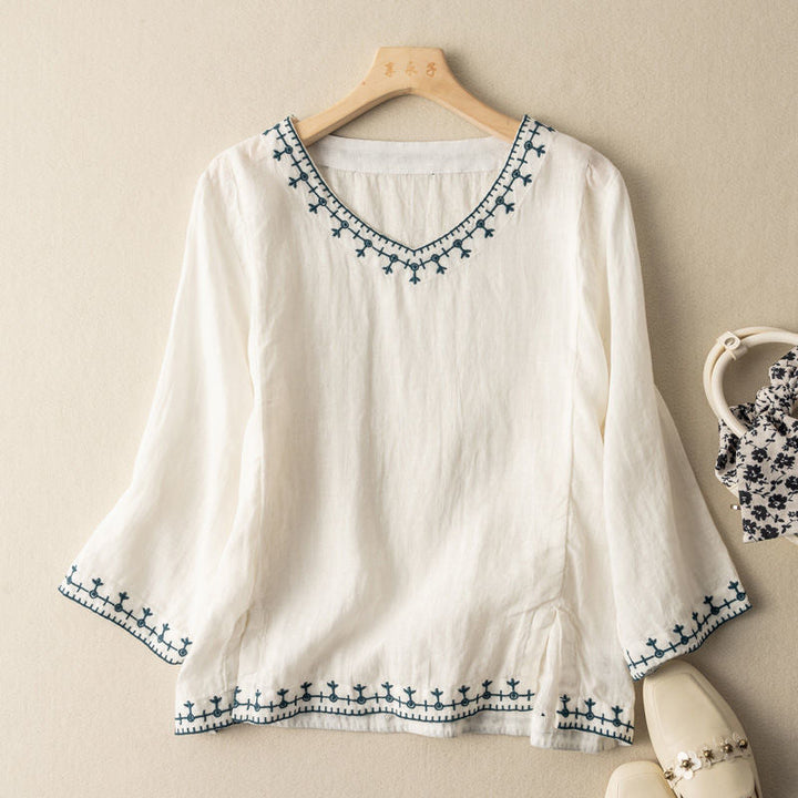 Women's elegant embroidered V-neck blouse in lightweight fabric, perfect for summer casual wear.
