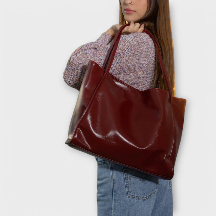 Back view of a classic black women's tote bag, simple and refined design