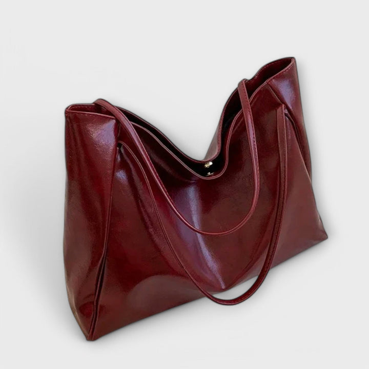 Pair of hands carrying an everyday tote bag, illustrating comfortable shoulder use