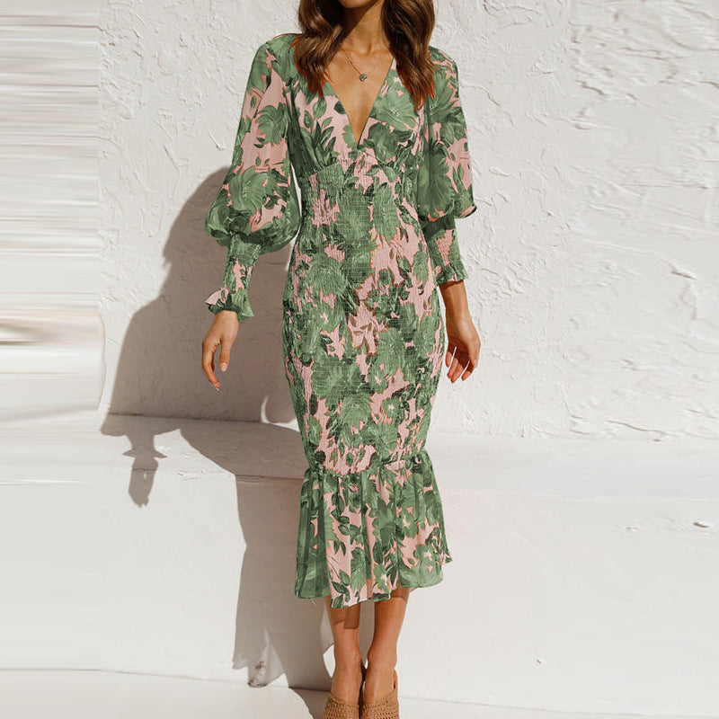 Elegant women's floral midi dress with a V-neck, long sleeves, and smocked details for a stylish summer day.