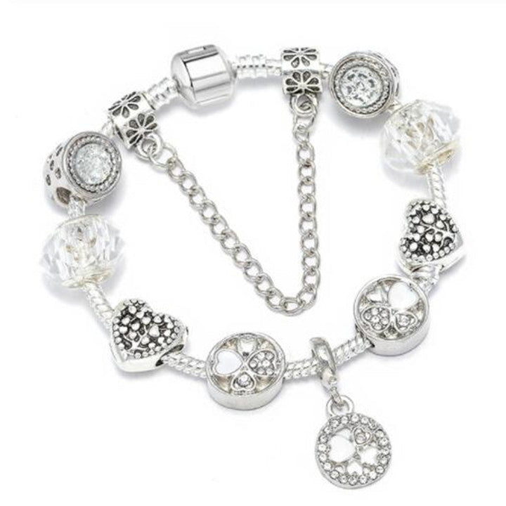 Delicate women's charm bracelet featuring peach blossom motif. Elegant fashion accessory, perfect for daily wear.