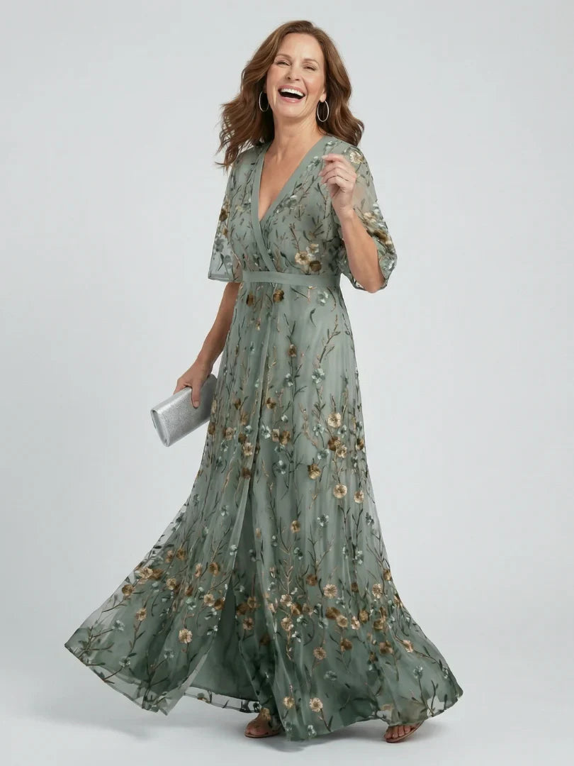 Elegant women's wedding guest dress, a sage green floral embroidered maxi gown for summer occasions.
