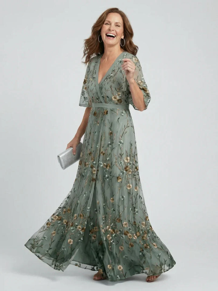 Elegant women's wedding guest dress, a sage green floral embroidered maxi gown for summer occasions.