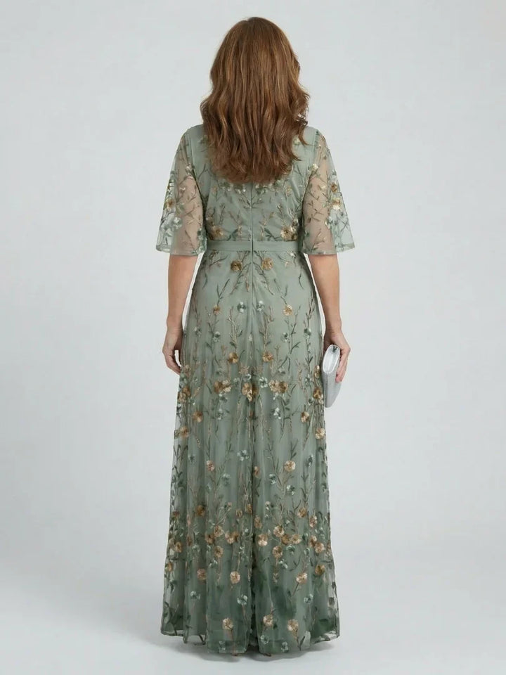 Back view of a women's sage green floral embroidered maxi dress, elegant for wedding guests & parties.