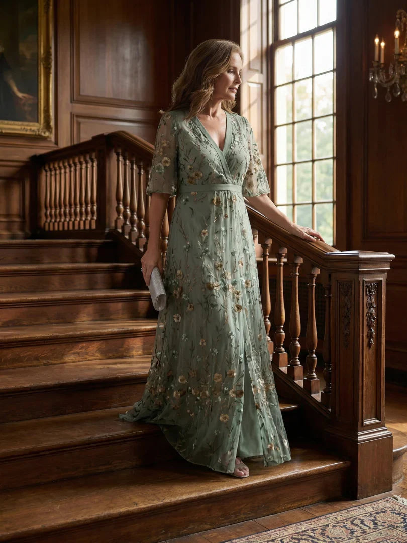 Model wearing an elegant sage green floral embroidered maxi dress, ideal for summer weddings & holidays.