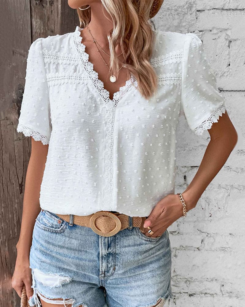 Lightweight V-neck summer blouse for women. Elegant, short sleeve, textured top, perfect for casual style.