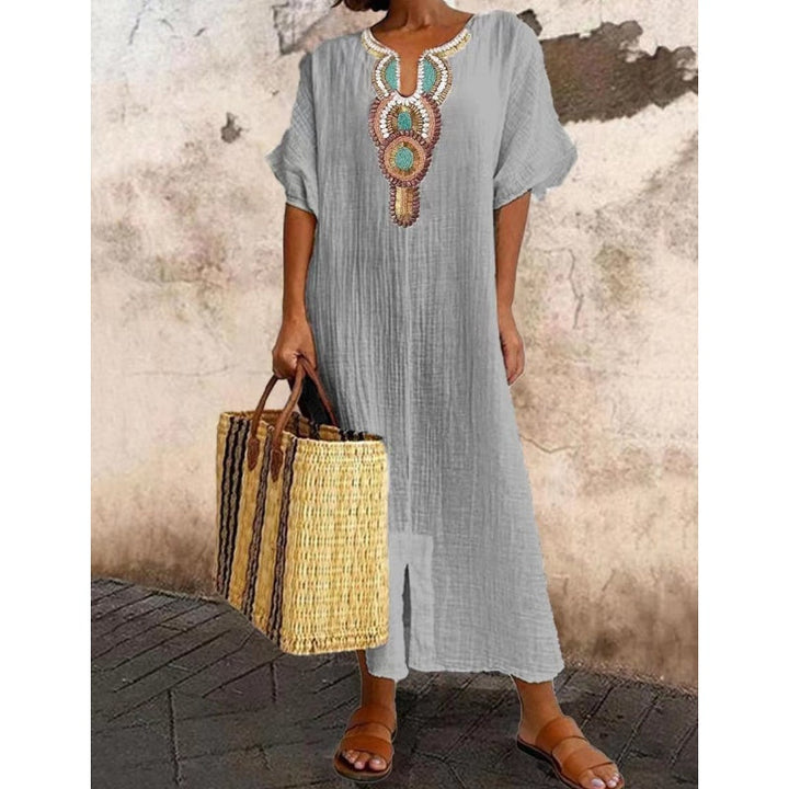 A-line women's maxi dress with intricate embroidery, ideal for spring resort wear