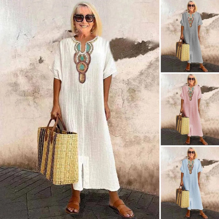 Full-length view of a woman wearing an embroidered linen blend maxi dress, ready for vacation