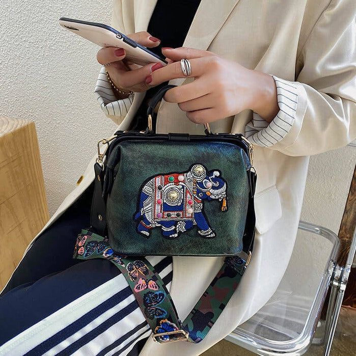 Intricate embroidered mandala design on a soft bohemian shoulder bag, lightweight & stylish.