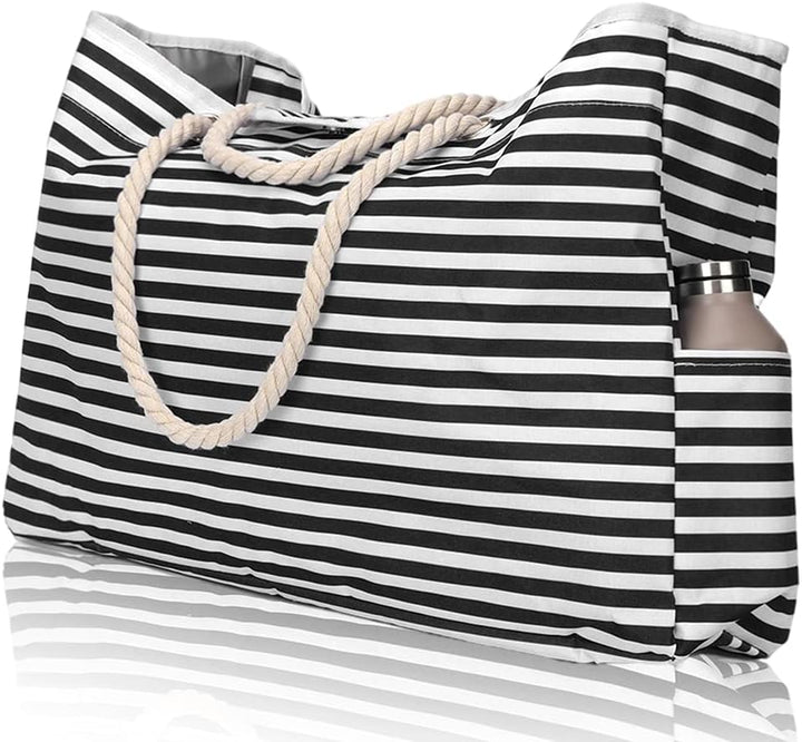 Woman carrying an extra large waterproof beach tote with striped design, perfect for a sunny vacation.