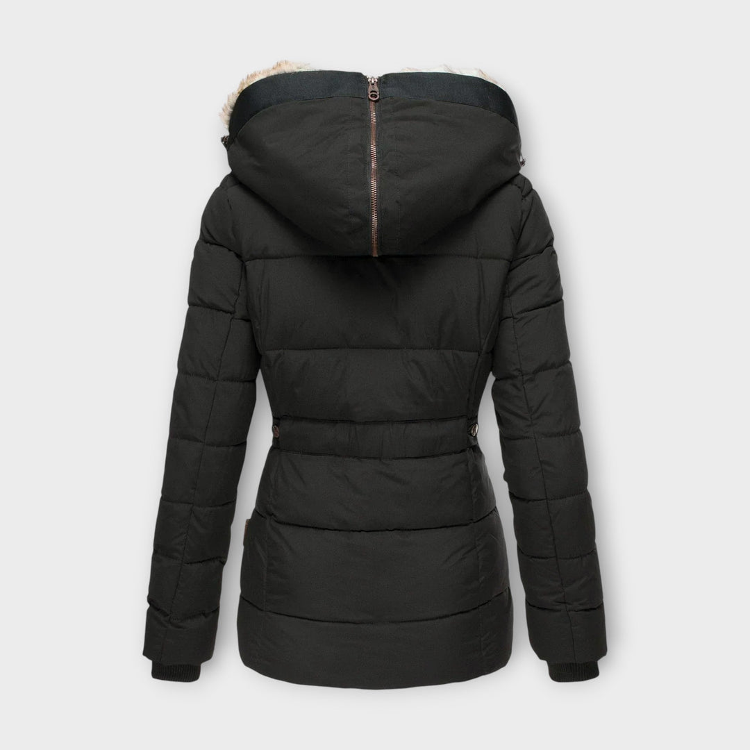 Woman wearing a cozy faux fur-lined winter parka jacket outdoors, ready for cold weather