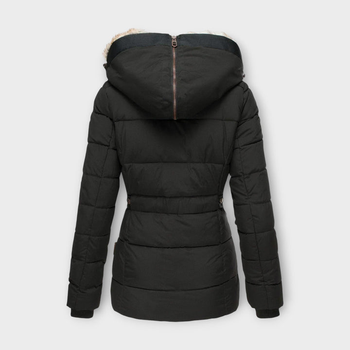 Woman wearing a cozy faux fur-lined winter parka jacket outdoors, ready for cold weather