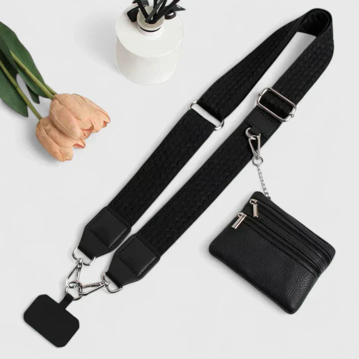 Lifestyle image: woman wearing a black vegan leather crossbody phone holder mini bag.