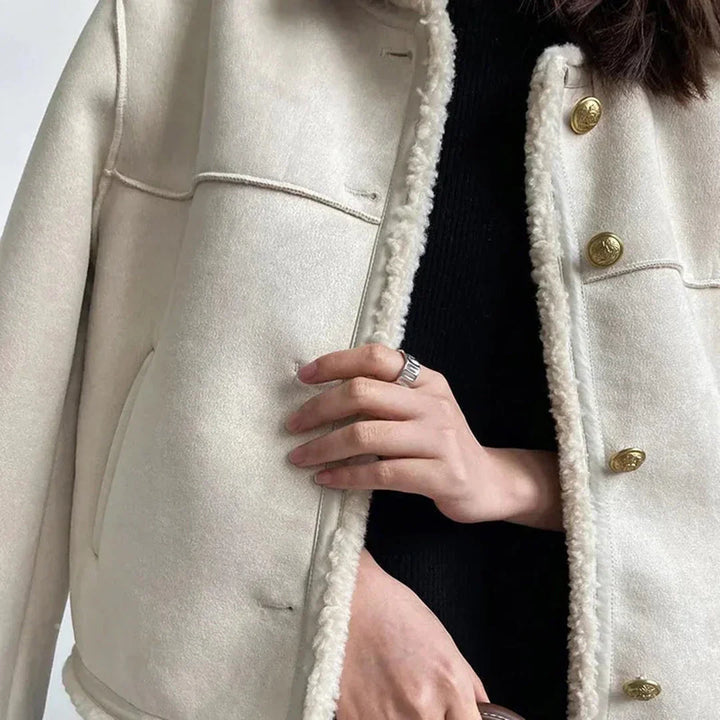 Back view of women's cream faux shearling jacket, winter outerwear trend