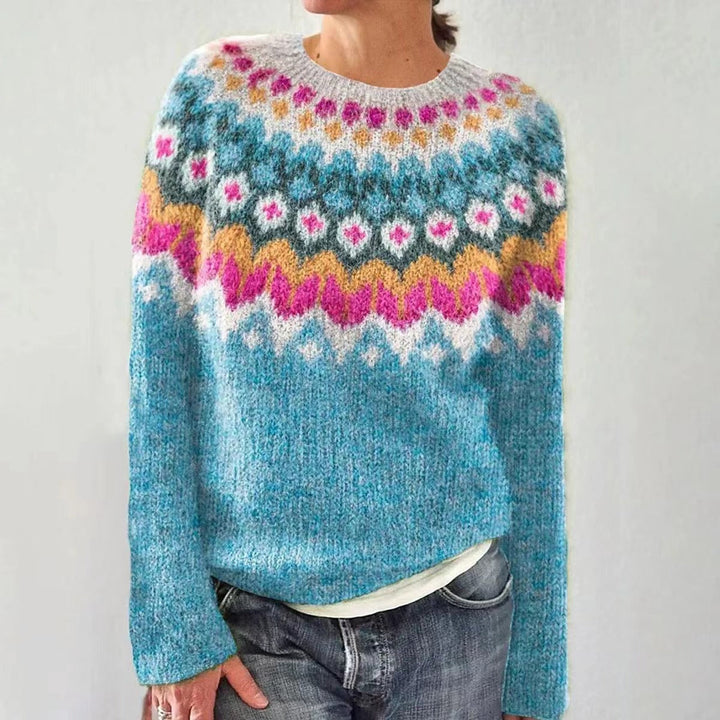 Cozy women's knitted Christmas sweater, red with white reindeer motif, ideal for festive winter wear.