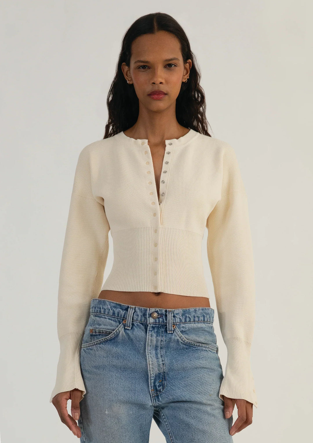 Stylish women's cropped knit cardigan with functional buttons. Elegant long sleeve top, perfect for layering.