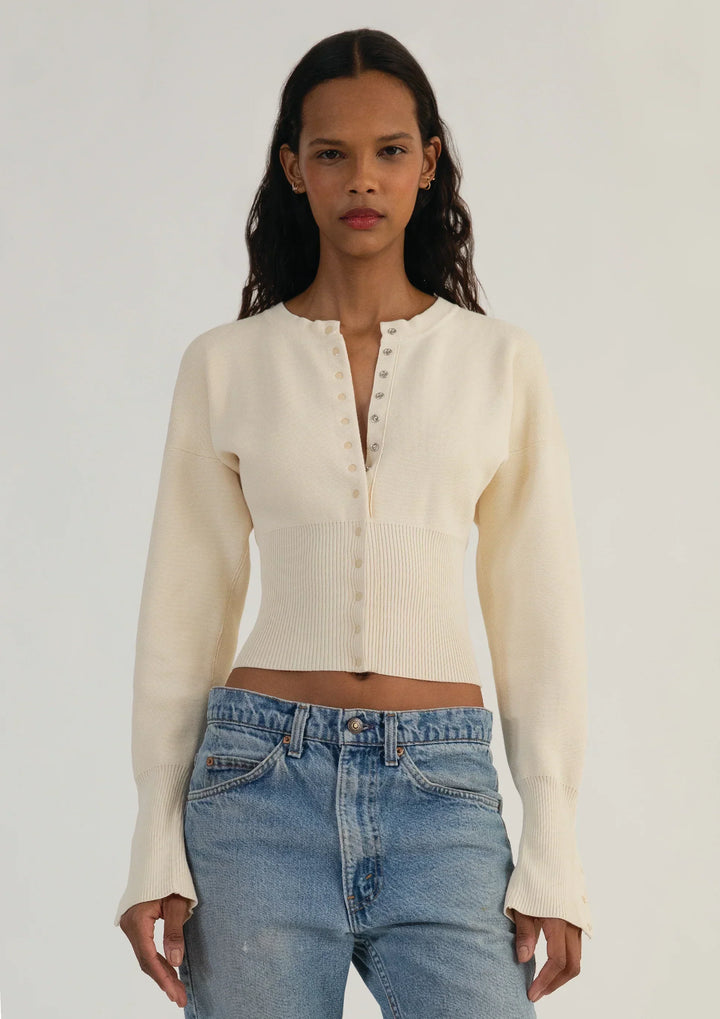 Stylish women's cropped knit cardigan with functional buttons. Elegant long sleeve top, perfect for layering.