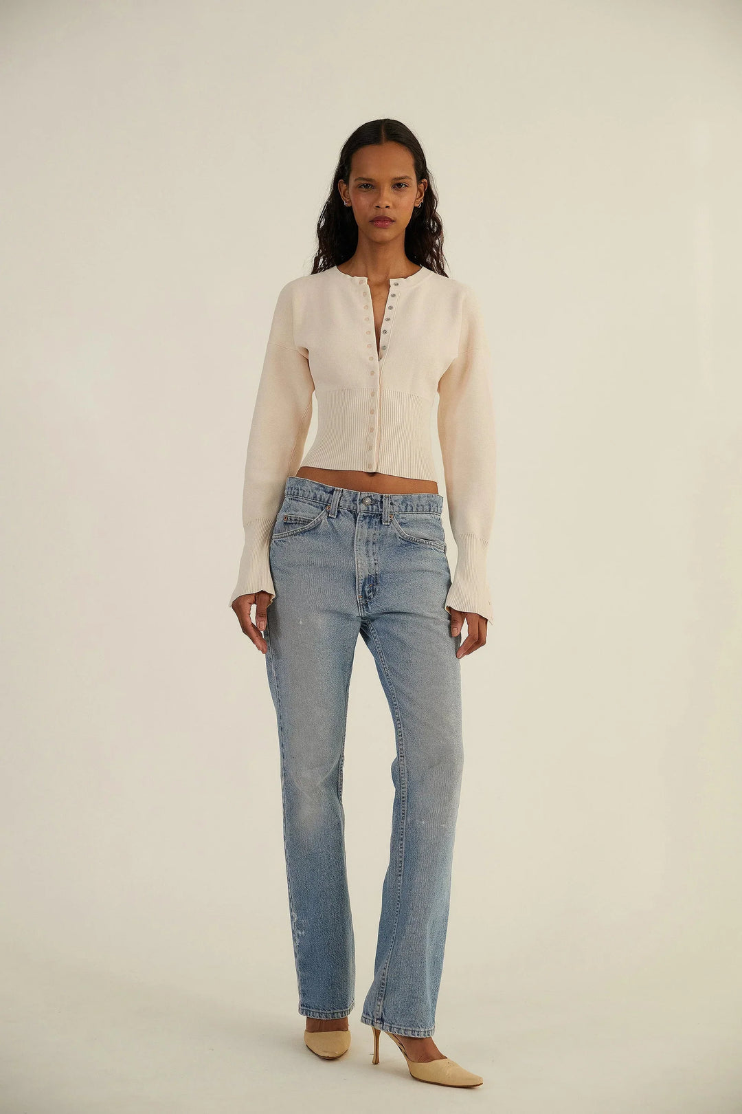 Chic long sleeve fitted cardigan for women, featuring a trendy cropped cut and button-up front.