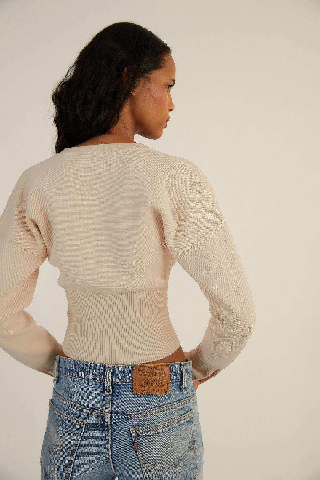 Versatile women's fitted knit cardigan, cropped and buttoned. Elegant long sleeve top for casual or dressy.
